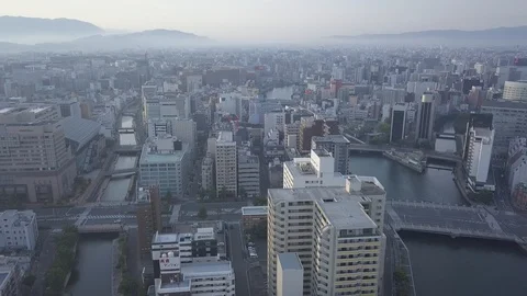Aerial Backwards over central Hakata with river,Fukuoka,Kyushu,Japan 動画素材 112664975