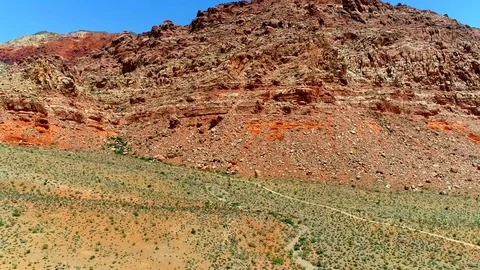Aerial backwards view through red rocks Stock Footage 91344701