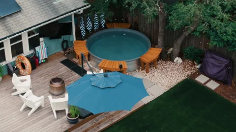 Aerial Backyard Stocktank Pool Deck Blue Umbrella Adirondack Chairs Empty Stock Footage 334351496