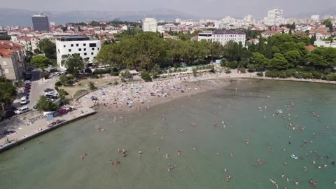 Aerial - Bacvice Beach, Split: bustling crowd near shoreline, Adriatic Sea Stock Footage 252253986
