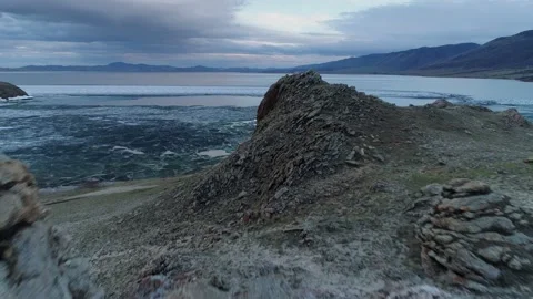 Aerial Baikal lake at dramatic sunset. Spring melting floes Dragon park Buryatia Stock Footage 202642446