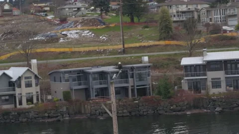 Aerial of bald eagle sitting on pole in Lake Washington, Seattle Stock Footage 204943354