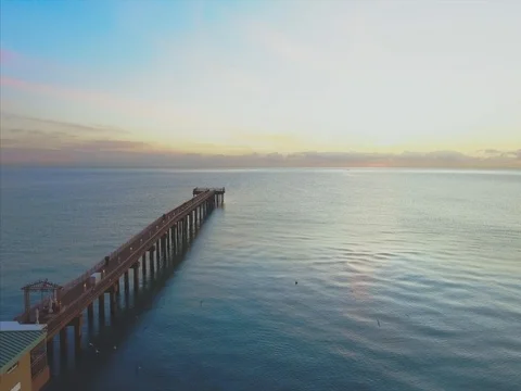 Aerial of beach and pier during sunrise Stock Footage 71634150
