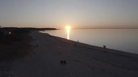 Aerial Beach Sunset Push in Along Beach w/People 4K@24FPS DLOG Video stock 297023264