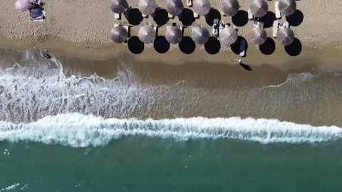 Aerial Beach Umbrella Pattern with Ocean Waves Top View Video stock 332978453
