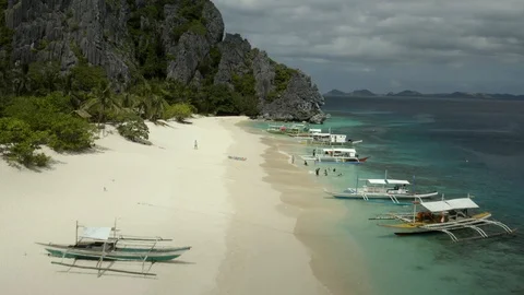 Aerial beach view with mountain range in the background Stock Footage 102837441