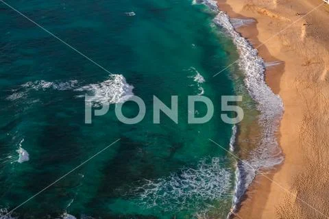 Aerial beach view with sea water and yellow sand Stock Photos