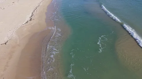 Aerial Beach Waves Creating Calm Patterns Along Sandy Seashore Stock Footage 325720009
