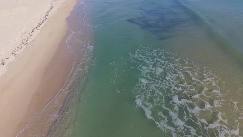 Aerial Beach Waves Creating Calm Patterns Along Sandy Seashore Stock Footage 325720010