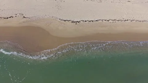 Aerial Beach Waves Creating Calm Patterns Along Sandy Seashore Stock Footage 325720012