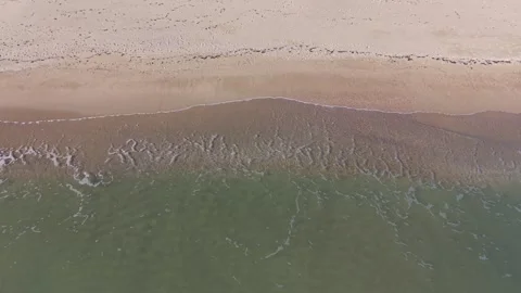 Aerial Beach Waves Creating Calm Patterns Along Sandy Seashore Stock Footage 325720013