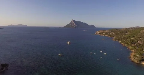 Aerial, beautiful bay in Sardinia with the view on Tavolara island on sunset, Stock Footage