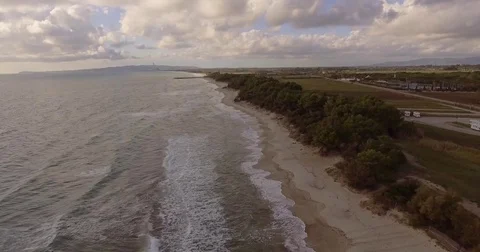 Aerial, beautiful empty sand beach and sea waves on a cloudy day 스톡 동영상 83458396