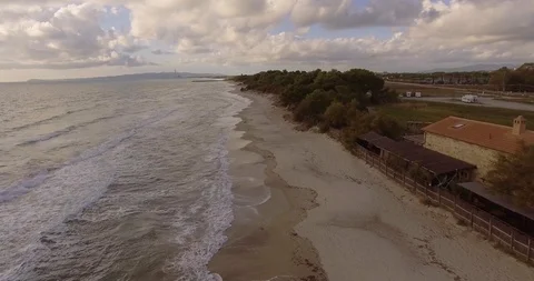 Aerial, beautiful empty sand beach and sea waves on a cloudy day 스톡 동영상 86738948
