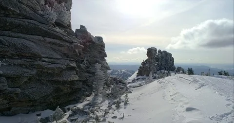 AERIAL: a beautiful flight with the drone between rocks covered with snow Video stock 117884348