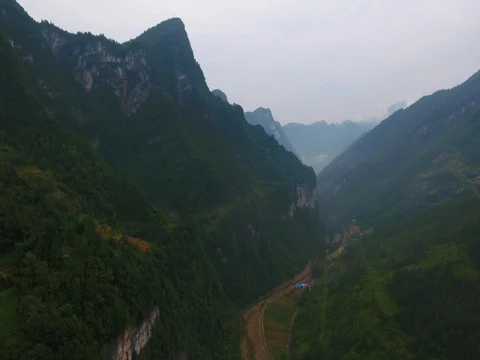 Aerial of beautiful green mountain range on a foggy day 스톡 동영상 79727494