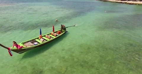 Aerial: Beautiful lady posing on longtail boat near the beach. Thailand. Phuket. Stock Footage 76712901