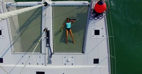 Aerial: Beautiful model posing on the luxury yaht. Phuket. Thailand. Stock Footage 76692261