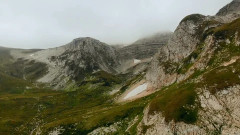 Aerial of beautiful mountain range fly over high epic cliffs rocks. Nature Stock-Footage 99430009