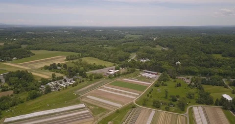 Aerial of beautiful patchwork field and green trees Stock Footage 103826404
