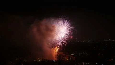 Aerial Beautiful View Of Exploding Fireworks, Drone Flying Over Houses In City - Stock Footage 169489841