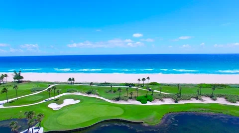 Aerial - Beautiful view of Golf Course next to ocean flying back on golf cour Stock Footage 66240729