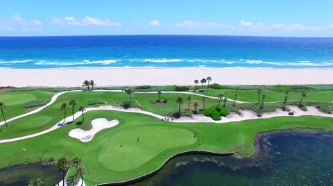 Aerial - Beautiful view of Golf Course next to ocean with players Stock Footage 66240738
