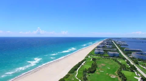 Aerial - Beautiful view of Golf Course next to ocean with kitesurfer. Stock Footage 66240820