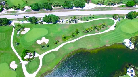 Aerial - Beautiful view of Golf Course next to ocean with road in the middle. Stock Footage 66240859