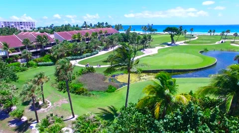 Aerial - Beautiful view of Golf Course next to ocean on a sunny day Stock Footage 66240862