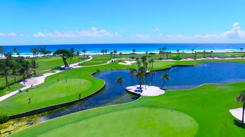 Aerial - Beautiful view of Golf Course next to ocean with golf players Stock Footage 66240876