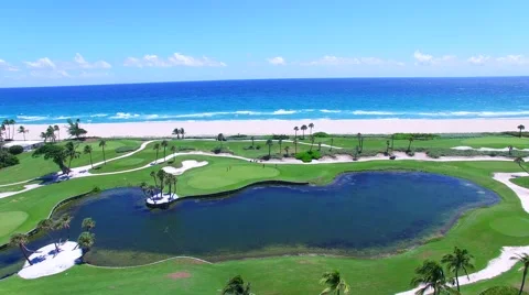 Aerial - Beautiful view of Golf Course next to ocean with clear sky Stock Footage 66240877