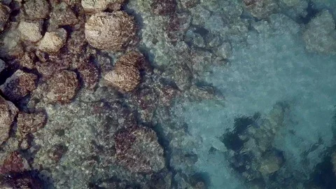 Aerial beautiful view. Waves are washing on stones and pebbles on the shore Stock Footage 125083222