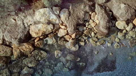 Aerial beautiful view. Waves are washing on stones and pebbles on the shore Stock Footage 125087176
