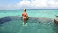 Aerial: Beautiful Young Woman Enjoying In Ocean Front Villa Pool Stock Footage