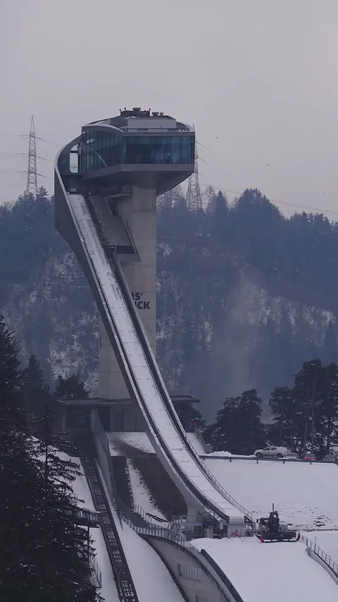 Aerial of Bergisel Ski Jump Tower in Innsbruck with Snow and Mist Stock Footage 331021516