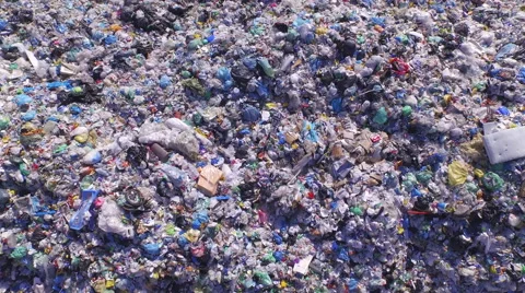 AERIAL: Big piles of empty bottles, bags and other plastic in the garbage dump Stock Footage 51826038