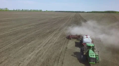 AERIAL: big tractor sowing spring wheat in the field Stock-Footage 62906089