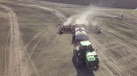 AERIAL: big tractor sowing spring wheat in the field Stock-Footage 62906092