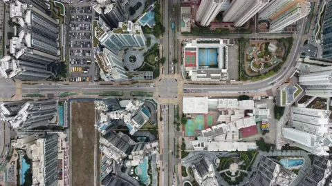 Aerial bird-eye view hovering above urban city road intersection, slowly zoom in Stock Footage 148275465