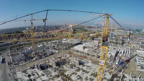 Aerial bird view of construction site moving up showing yellow tower crane 4k Stock Footage 73351616