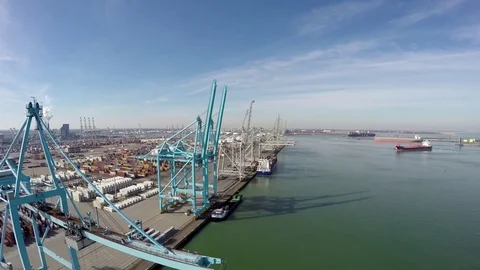 Aerial bird view flying backwards over harbor area past blue harbour cranes 4k Stock Footage 73555020