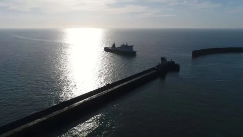 Aerial bird view footage of ferry silhouette arriving at harbor 4k Stock Footage 101192585