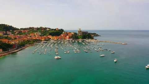 Aerial bird view moving towards Trapani marina showing several sailing boats in Stock Footage 128766419