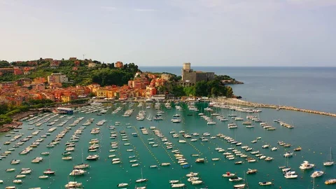 Aerial bird view moving towards Trapani marina showing several sailing boats in Stock Footage 128766427