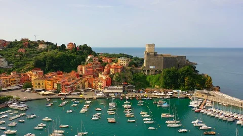 Aerial bird view moving towards Trapani marina showing several sailing boats in Stock Footage 128766463