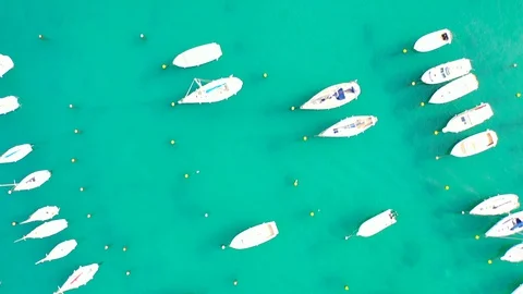 Aerial bird view moving towards Trapani marina showing several sailing boats in Stock Footage 128767022