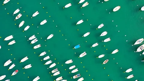 Aerial bird view moving towards Trapani marina showing several sailing boats in Stock Footage 128767054