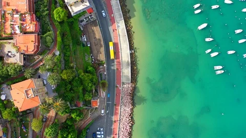 Aerial bird view moving towards Trapani marina showing several sailing boats in Stock Footage 128767097
