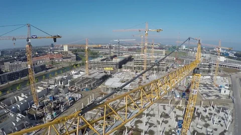 Aerial birds eye view of construction site drone moving past tall yellow arm 4k Stock Footage 73351289